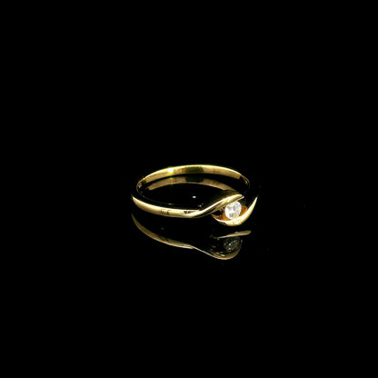 Solitaire diamond twist ring in 18K yellow gold featuring a 0.10 carat natural diamond