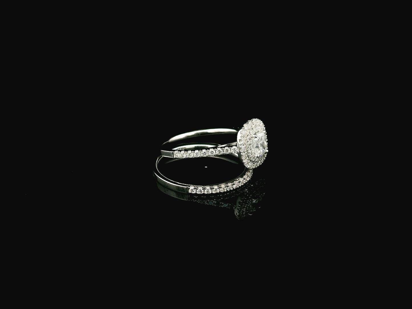GIA certified cushion cut diamond bridal ring set in 18K white gold with halo engagement ring and matching diamond wedding band.