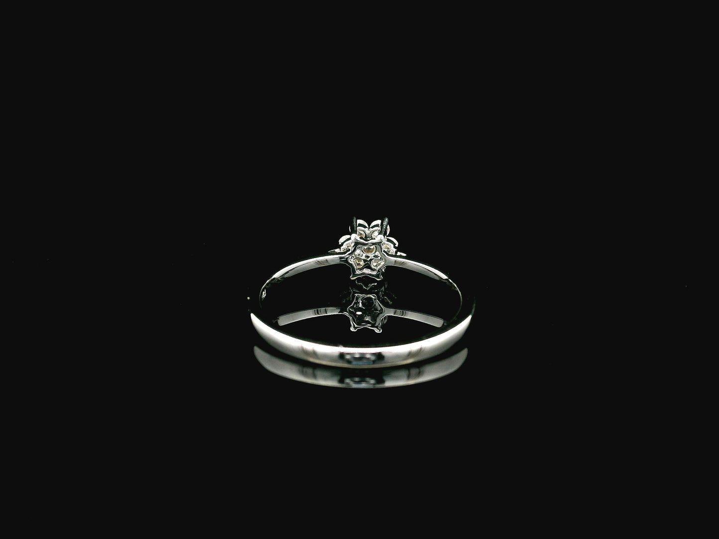 18K white gold floral diamond cluster ring with delicate minimalist design.