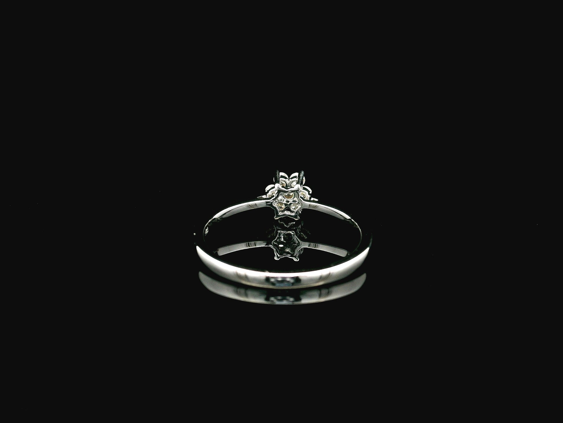 18K white gold floral diamond cluster ring with delicate minimalist design.