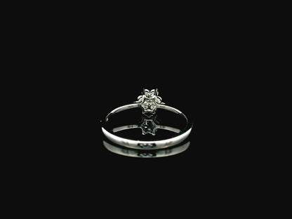 18K white gold floral diamond cluster ring with delicate minimalist design.