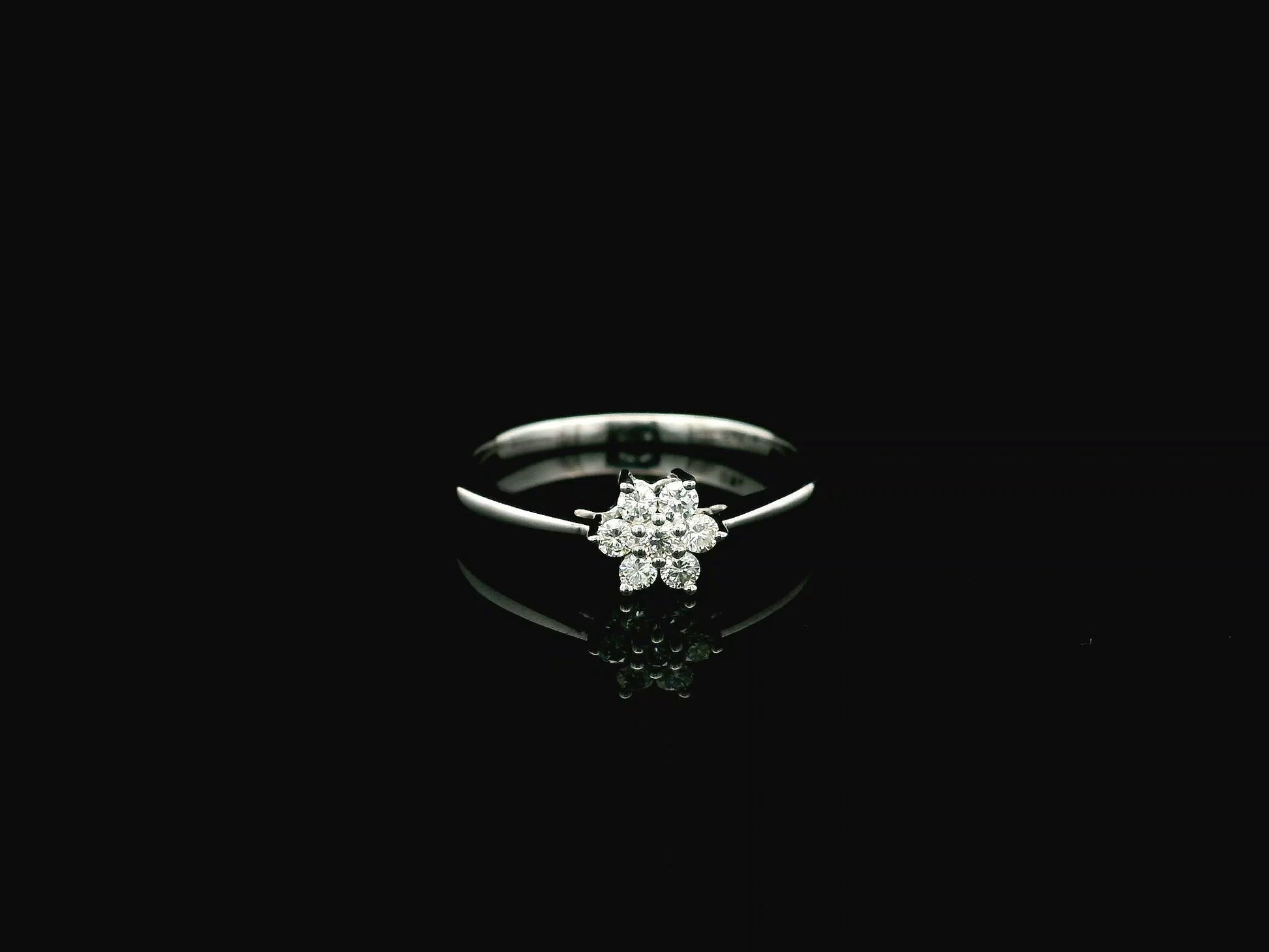 18K white gold floral diamond cluster ring with delicate minimalist design.