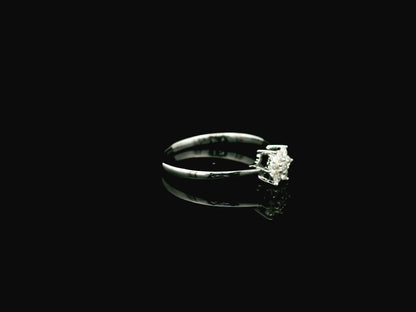 18K white gold floral diamond cluster ring with delicate minimalist design.