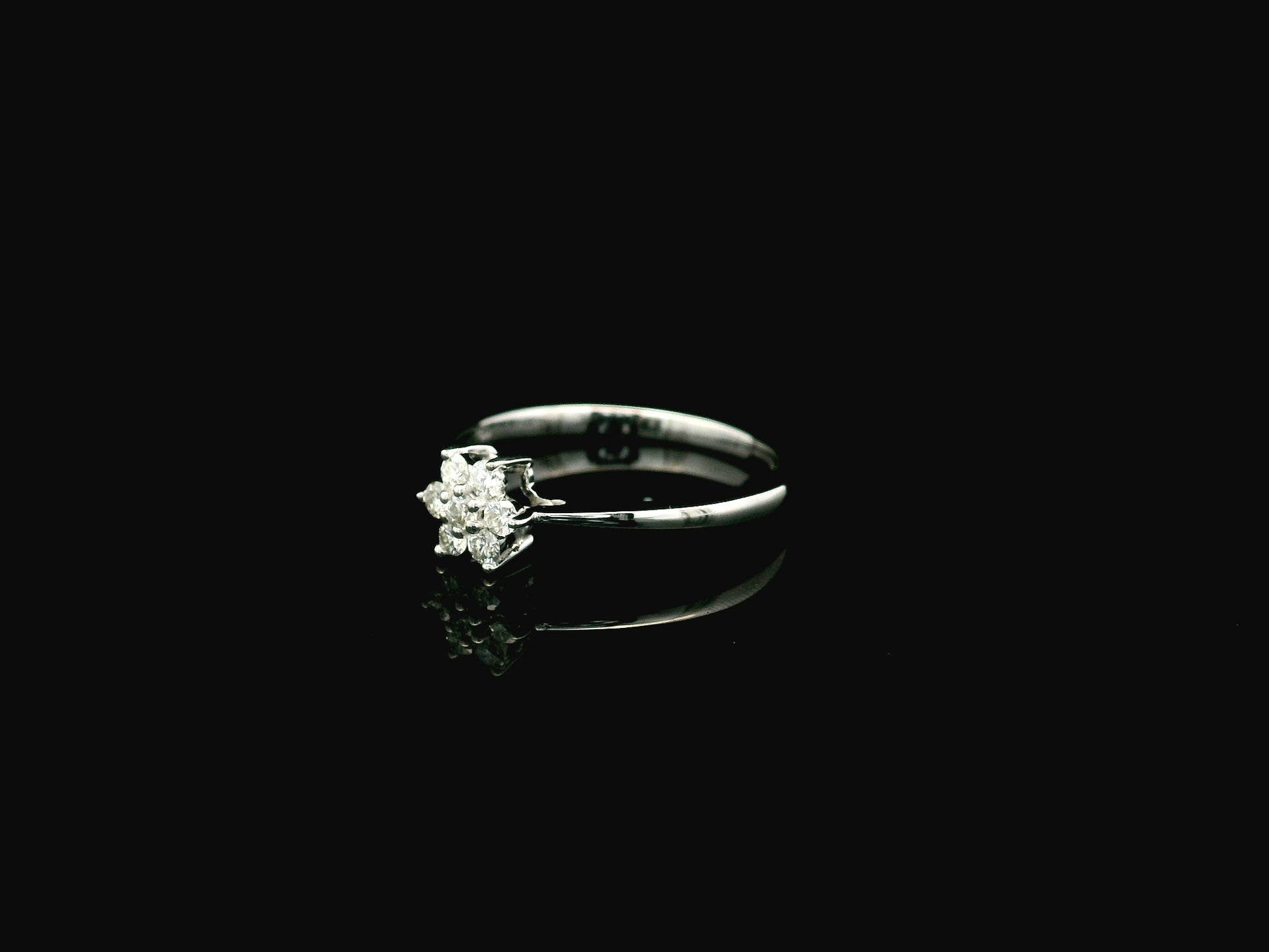 18K white gold floral diamond cluster ring with delicate minimalist design.