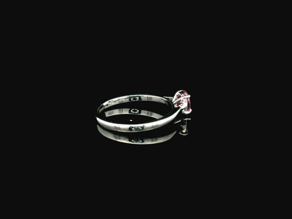18K white gold pink sapphire solitaire ring featuring a 0.91 carat round pink sapphire in a classic four-prong setting