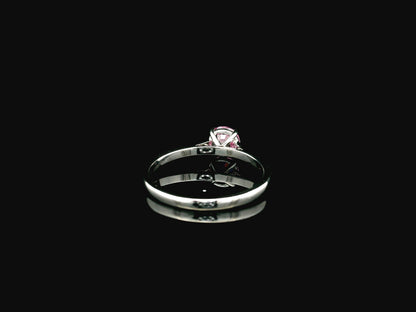 18K white gold pink sapphire solitaire ring featuring a 0.91 carat round pink sapphire in a classic four-prong setting
