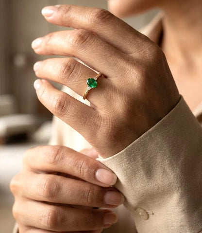 Dainty oval emerald and diamond ring in 18K yellow gold by Emirates Diamonds