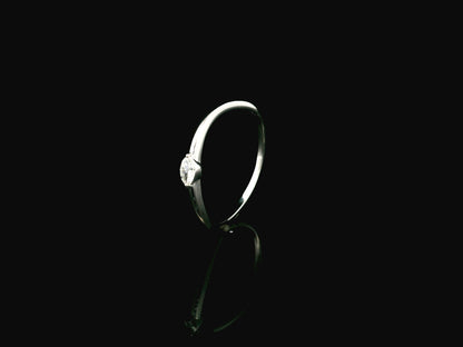 18K white gold solitaire ring featuring a 0.09 carat marquise cut natural diamond in a classic prong setting.