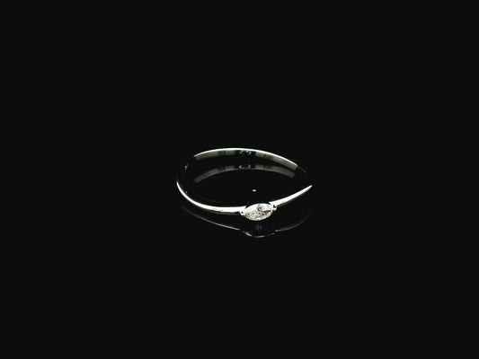 18K white gold solitaire ring featuring a 0.09 carat marquise cut natural diamond in a classic prong setting.