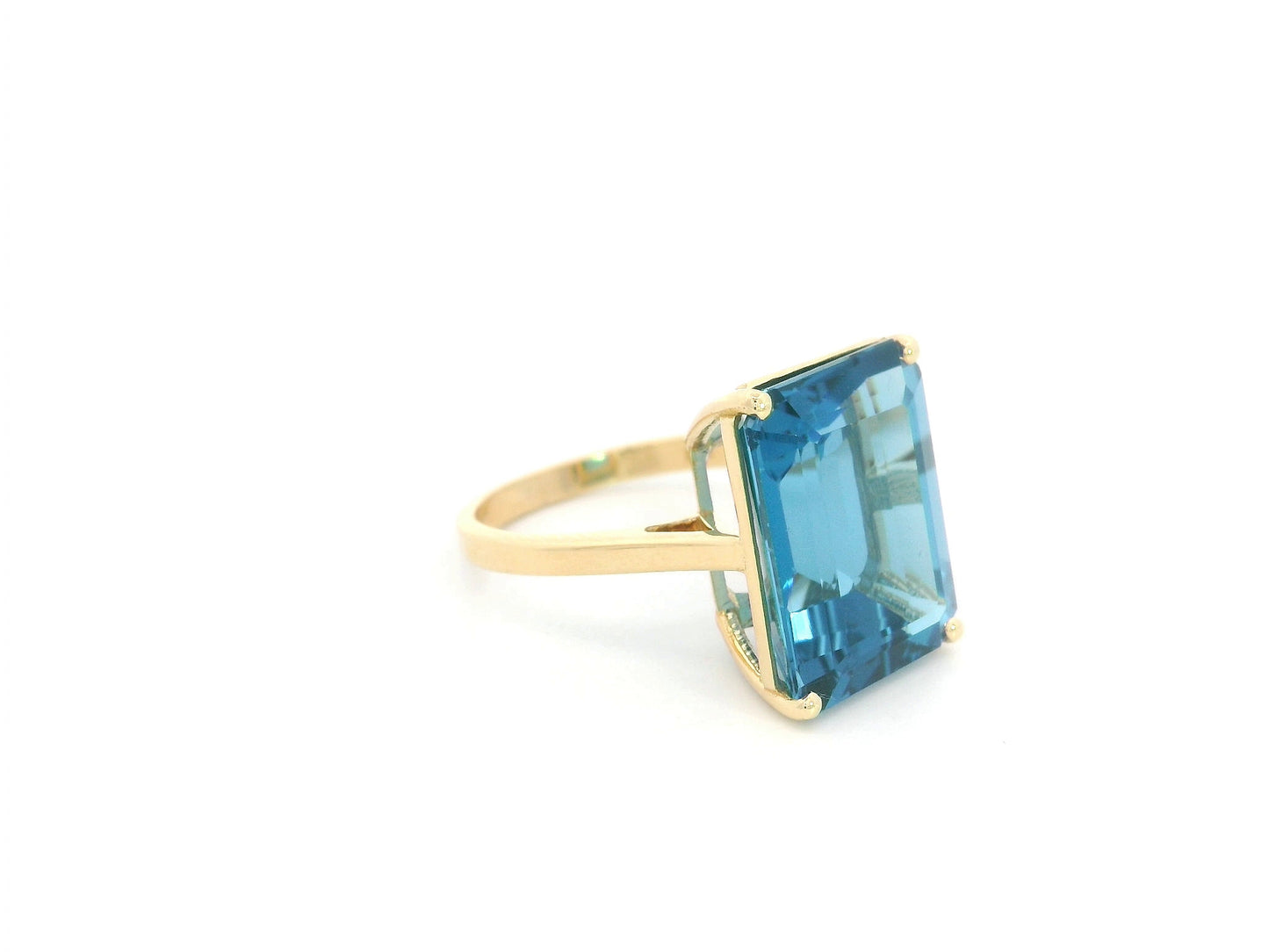 14.60 carat emerald cut London Blue Topaz solitaire ring in 18K yellow gold