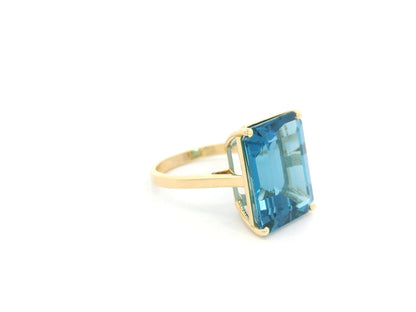 14.60 carat emerald cut London Blue Topaz solitaire ring in 18K yellow gold