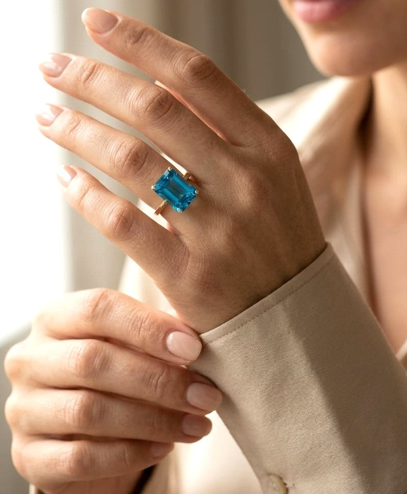 14.60 carat emerald cut London Blue Topaz solitaire ring in 18K yellow gold