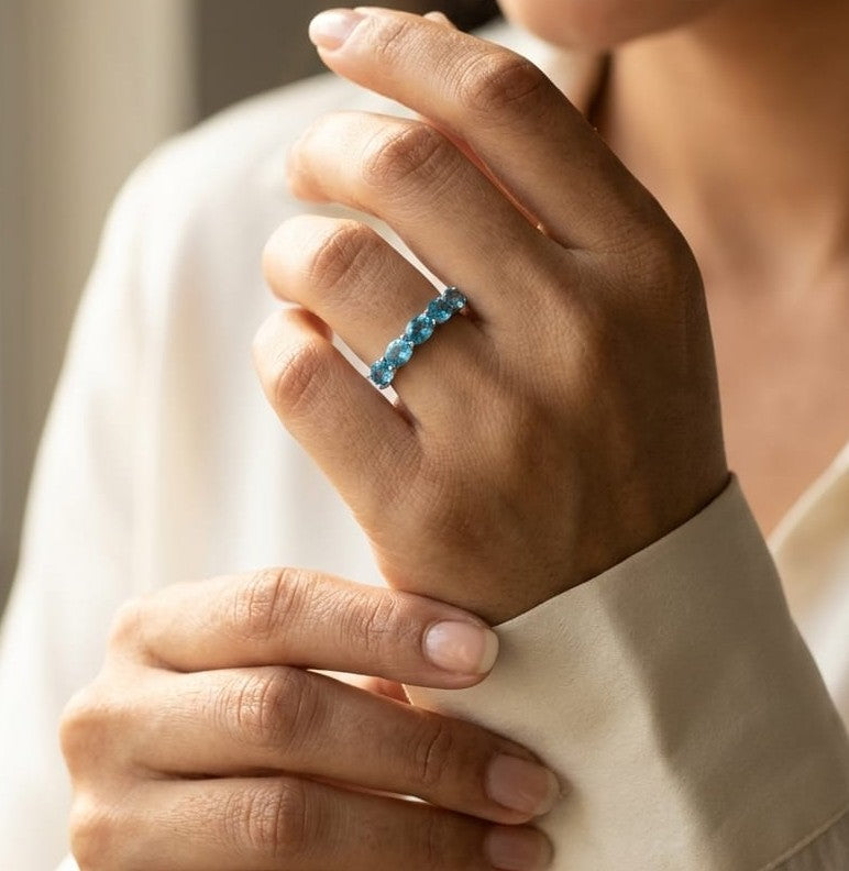 Blue Topaz five stone ring in 18K white gold featuring five oval blue topaz gemstones totaling 1.42 carats