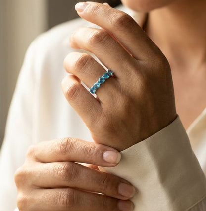 Blue Topaz five stone ring in 18K white gold featuring five oval blue topaz gemstones totaling 1.42 carats