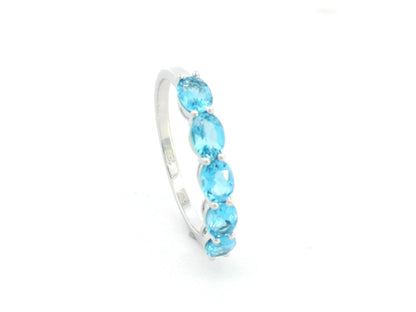 Blue Topaz five stone ring in 18K white gold featuring five oval blue topaz gemstones totaling 1.42 carats