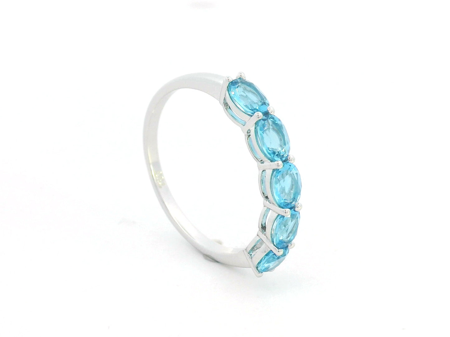 Blue Topaz five stone ring in 18K white gold featuring five oval blue topaz gemstones totaling 1.42 carats