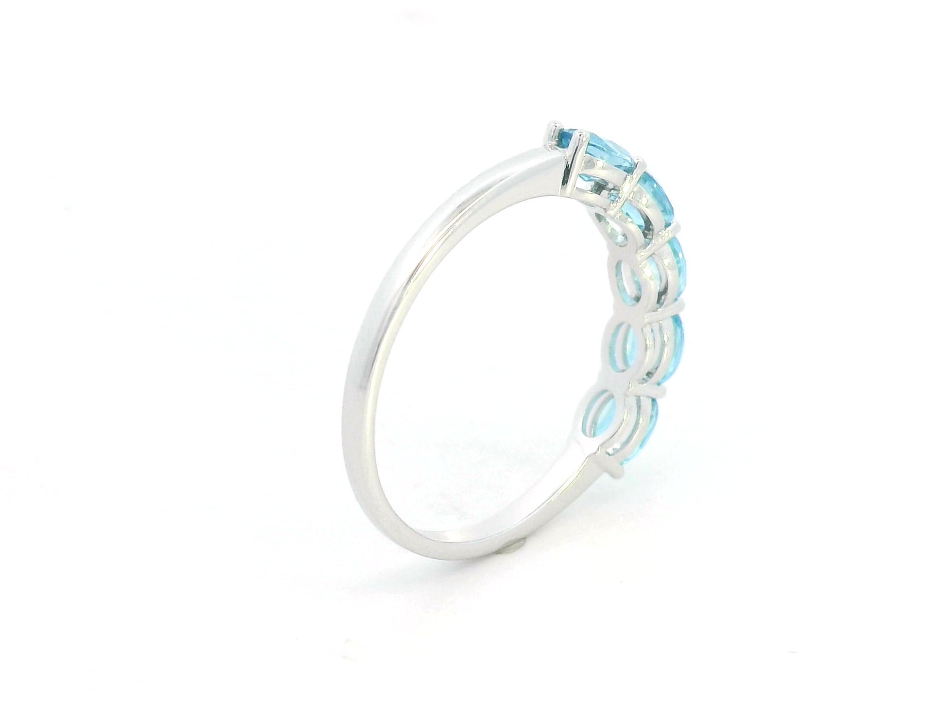 Blue Topaz five stone ring in 18K white gold featuring five oval blue topaz gemstones totaling 1.42 carats