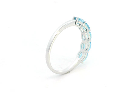 Blue Topaz five stone ring in 18K white gold featuring five oval blue topaz gemstones totaling 1.42 carats
