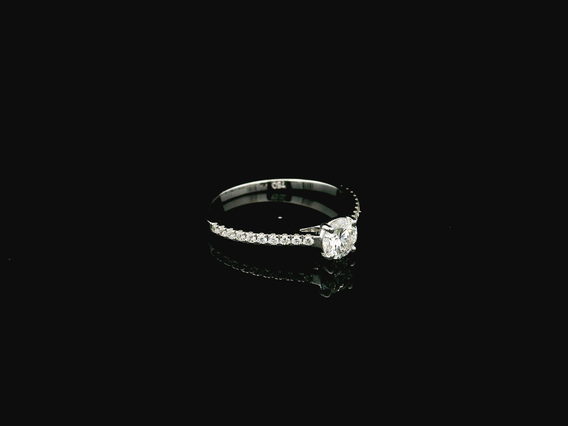 GIA certified 0.50 carat round diamond solitaire engagement ring in 18K white gold with diamond pavé band