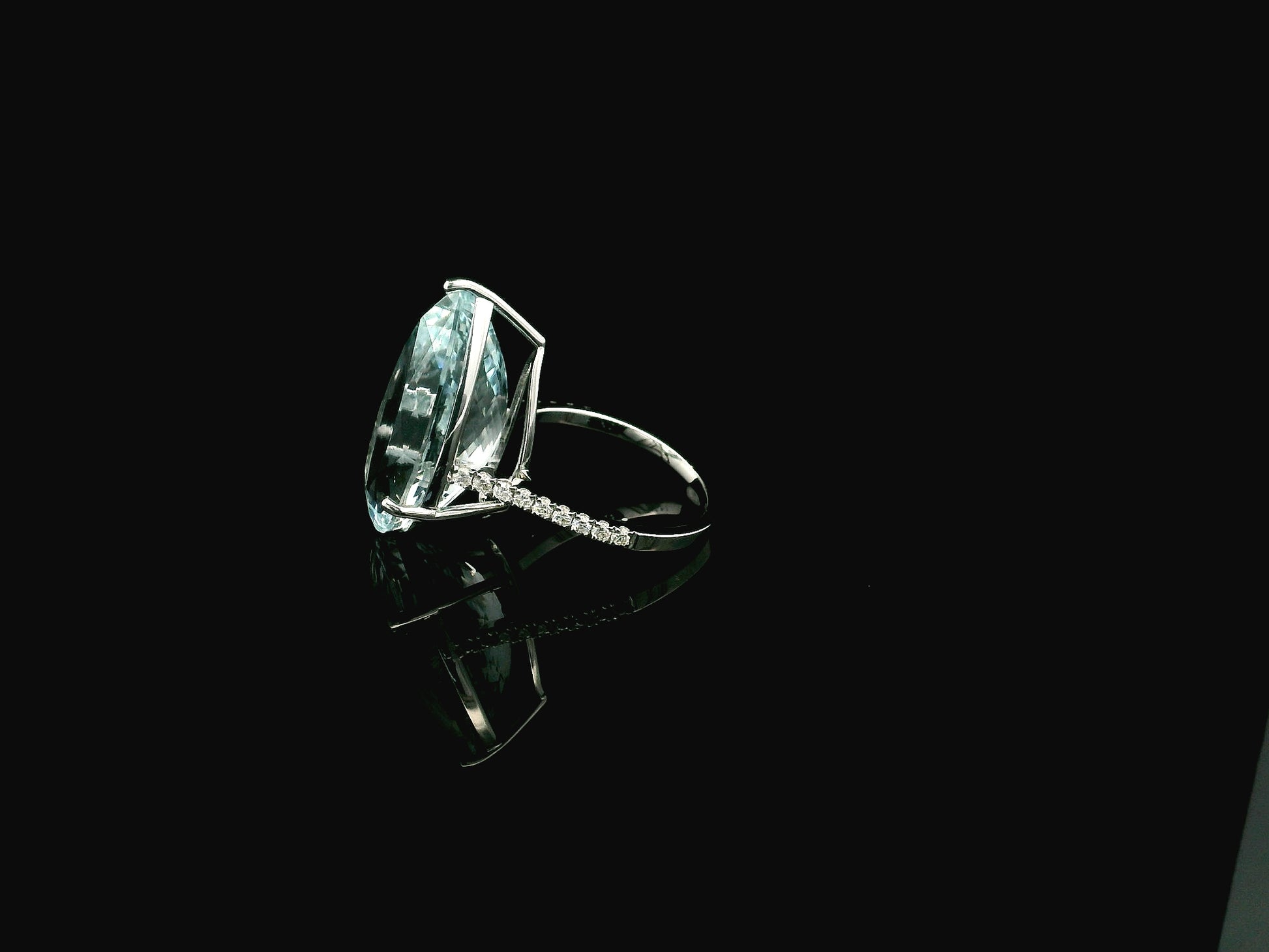 15.60 carat pear cut aquamarine ring in 18K white gold with pavé diamond band