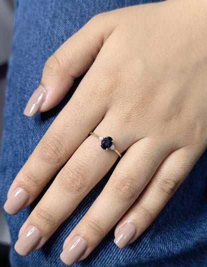Oval blue sapphire and diamond three stone ring in 18K yellow gold
