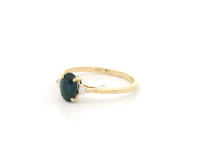 Oval blue sapphire and diamond three stone ring in 18K yellow gold