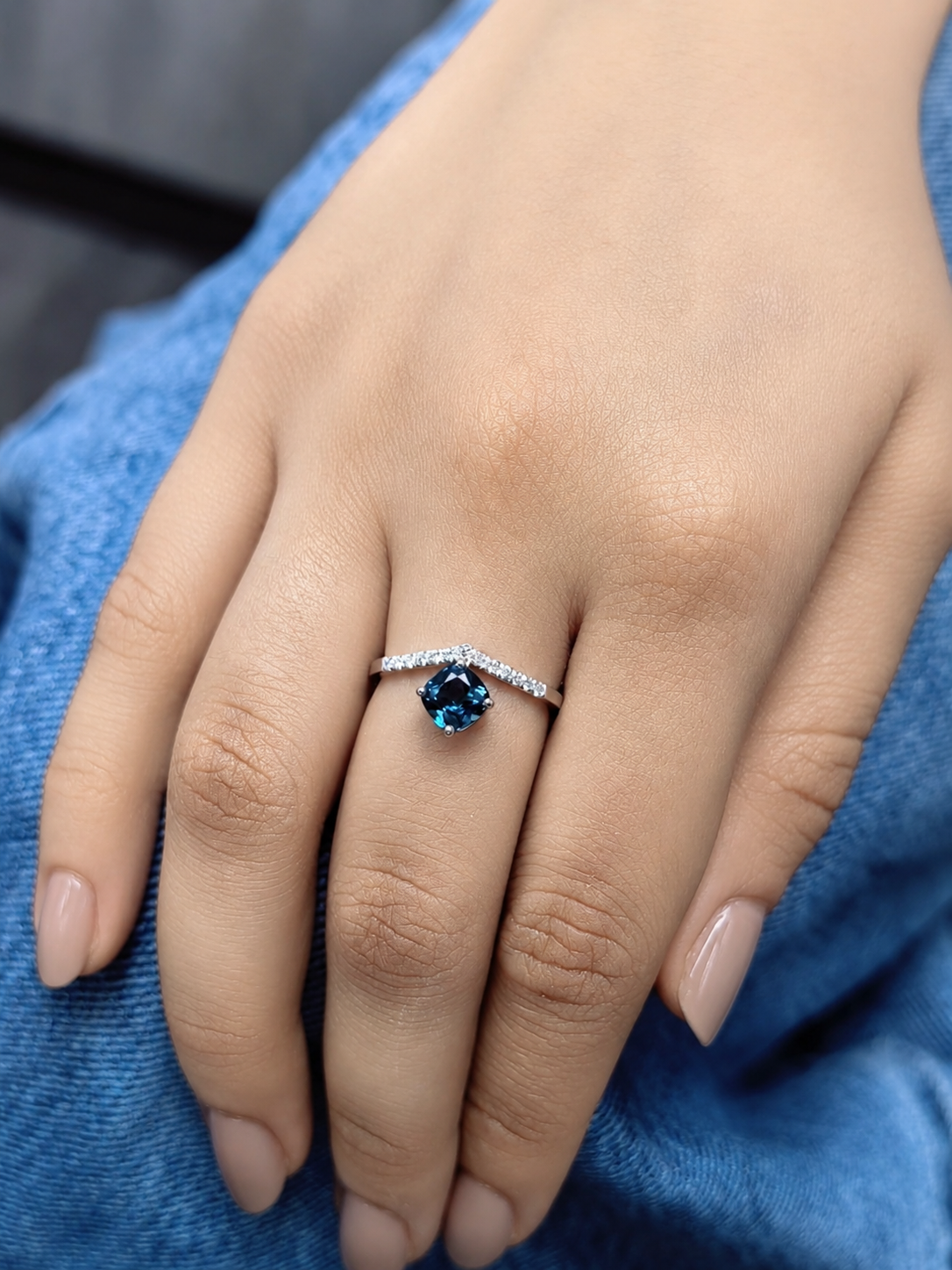 18K white gold London Blue Topaz ring featuring a 1.00 carat oval London Blue Topaz with 0.18 carat natural diamond accents on an elegant diamond-set band.