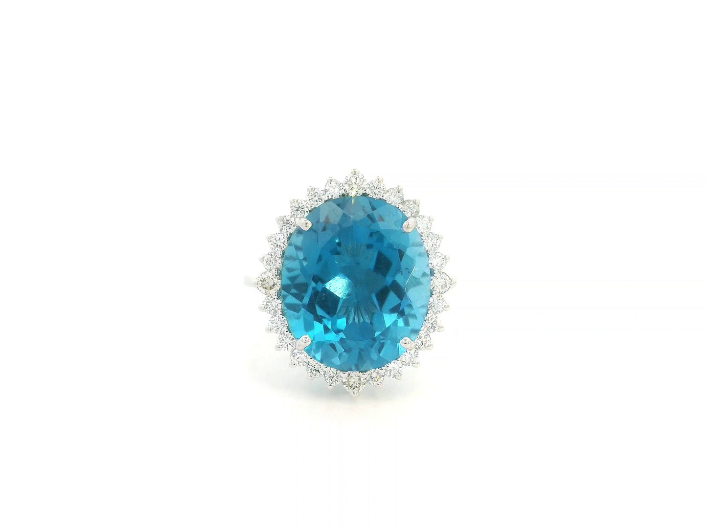 9.81 carat oval London Blue Topaz halo ring with natural diamonds in 18K white gold.