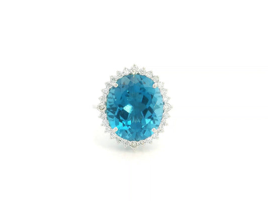 9.81 carat oval London Blue Topaz halo ring with natural diamonds in 18K white gold.