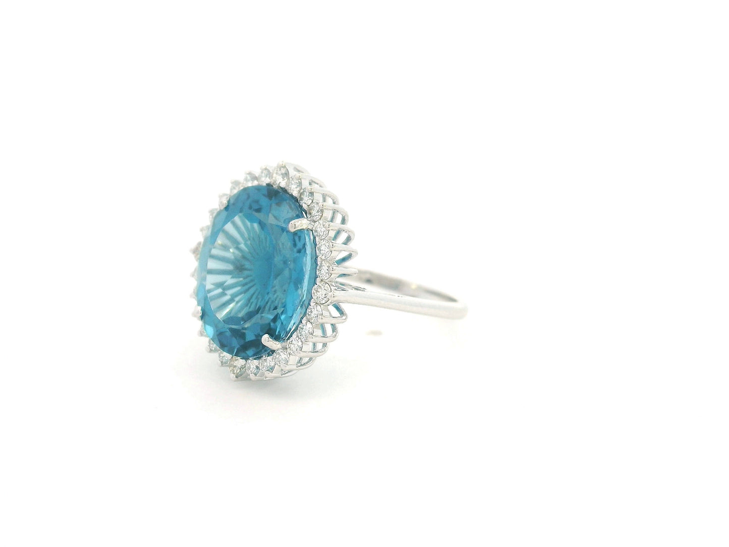 9.81 carat oval London Blue Topaz halo ring with natural diamonds in 18K white gold.