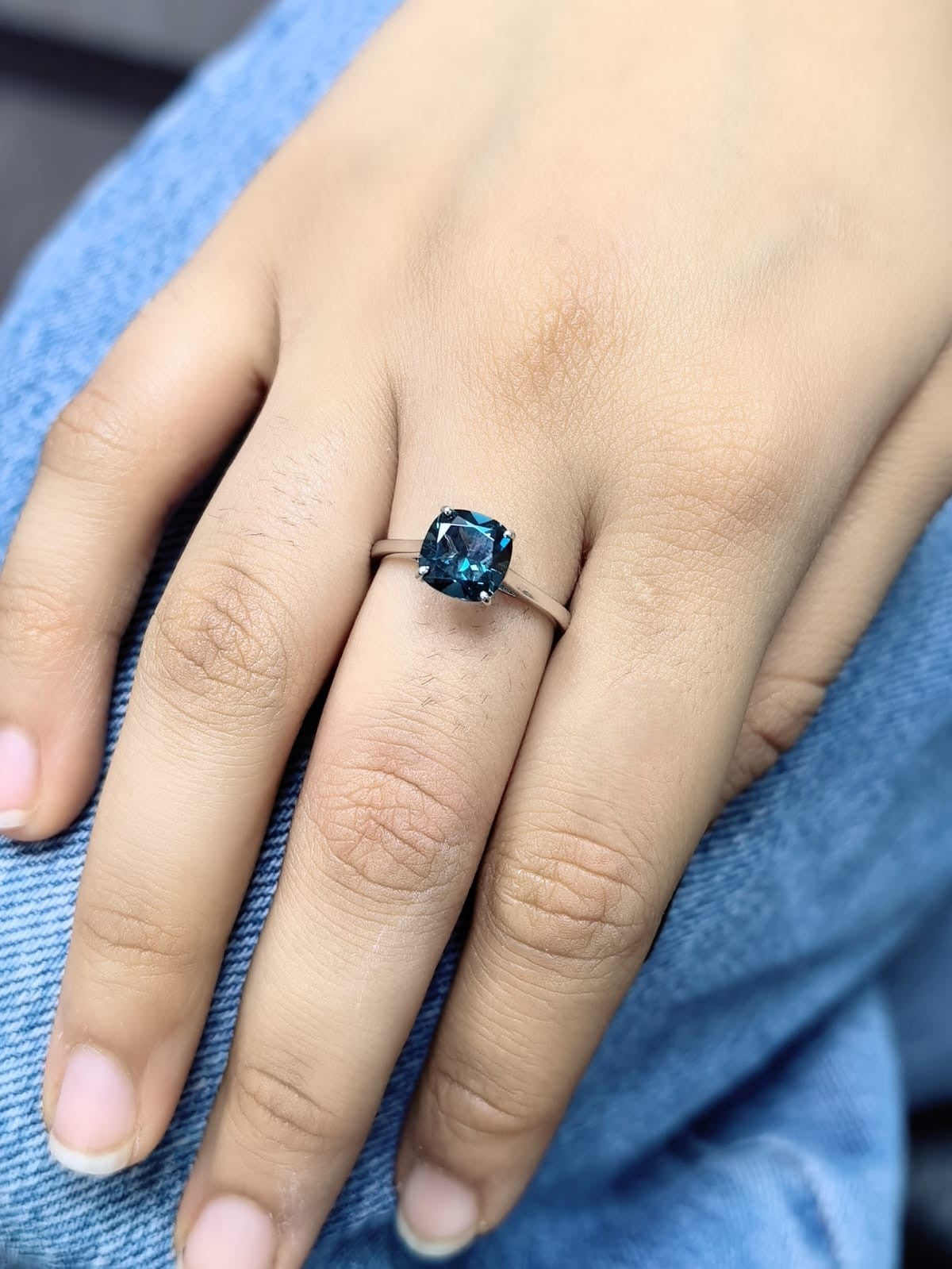 2.42 carat cushion cut London Blue Topaz solitaire ring in 18K white gold.