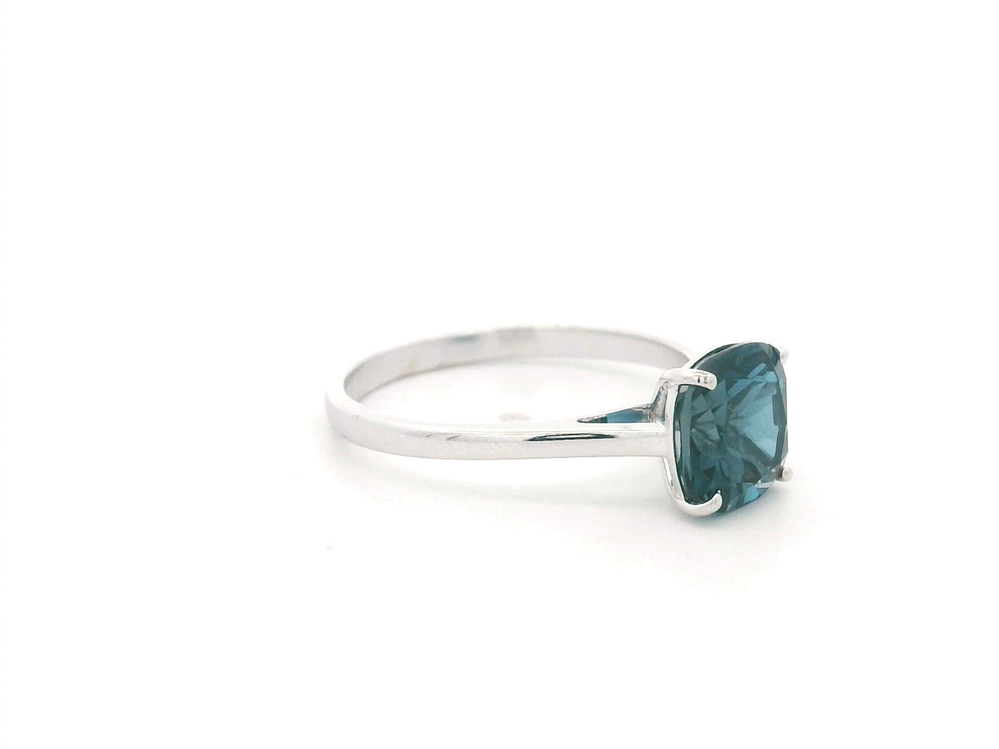 2.42 carat cushion cut London Blue Topaz solitaire ring in 18K white gold.