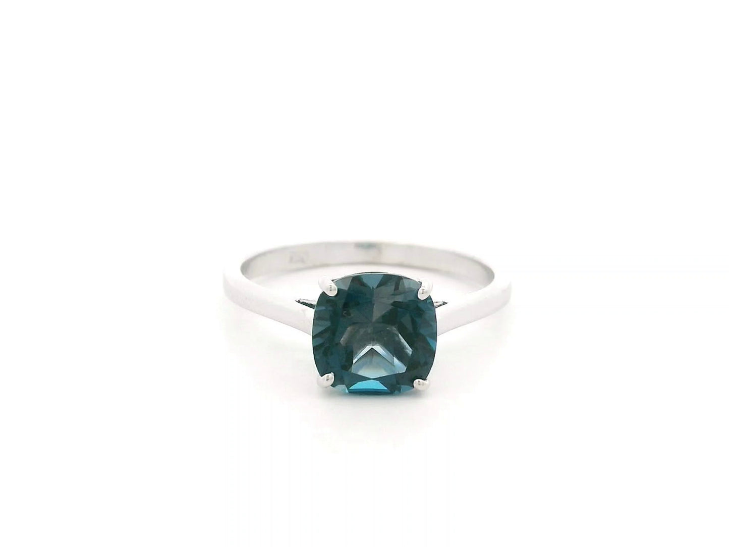 2.42 carat cushion cut London Blue Topaz solitaire ring in 18K white gold.