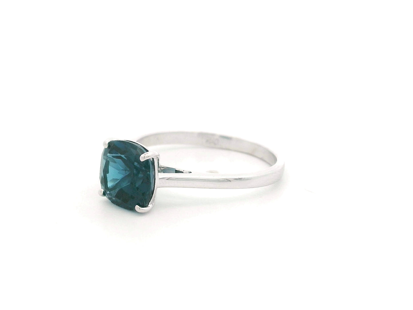 2.42 carat cushion cut London Blue Topaz solitaire ring in 18K white gold.