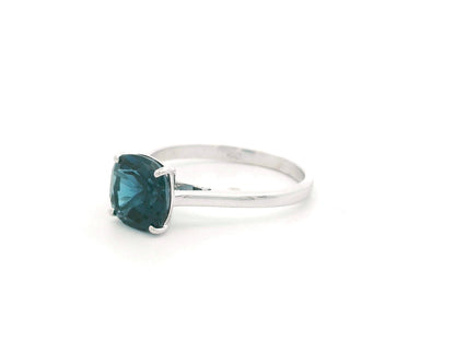 2.42 carat cushion cut London Blue Topaz solitaire ring in 18K white gold.