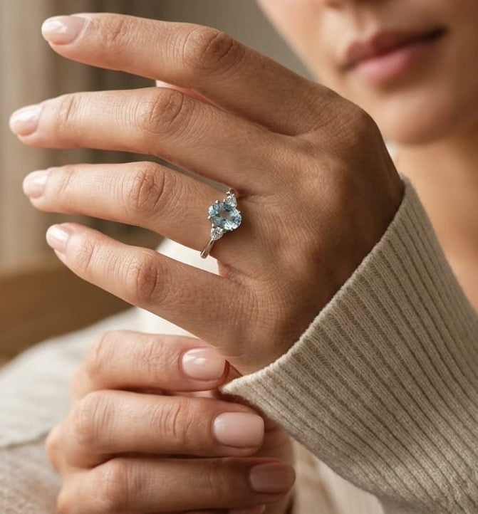 Oval aquamarine and diamond three stone ring in 18K white gold