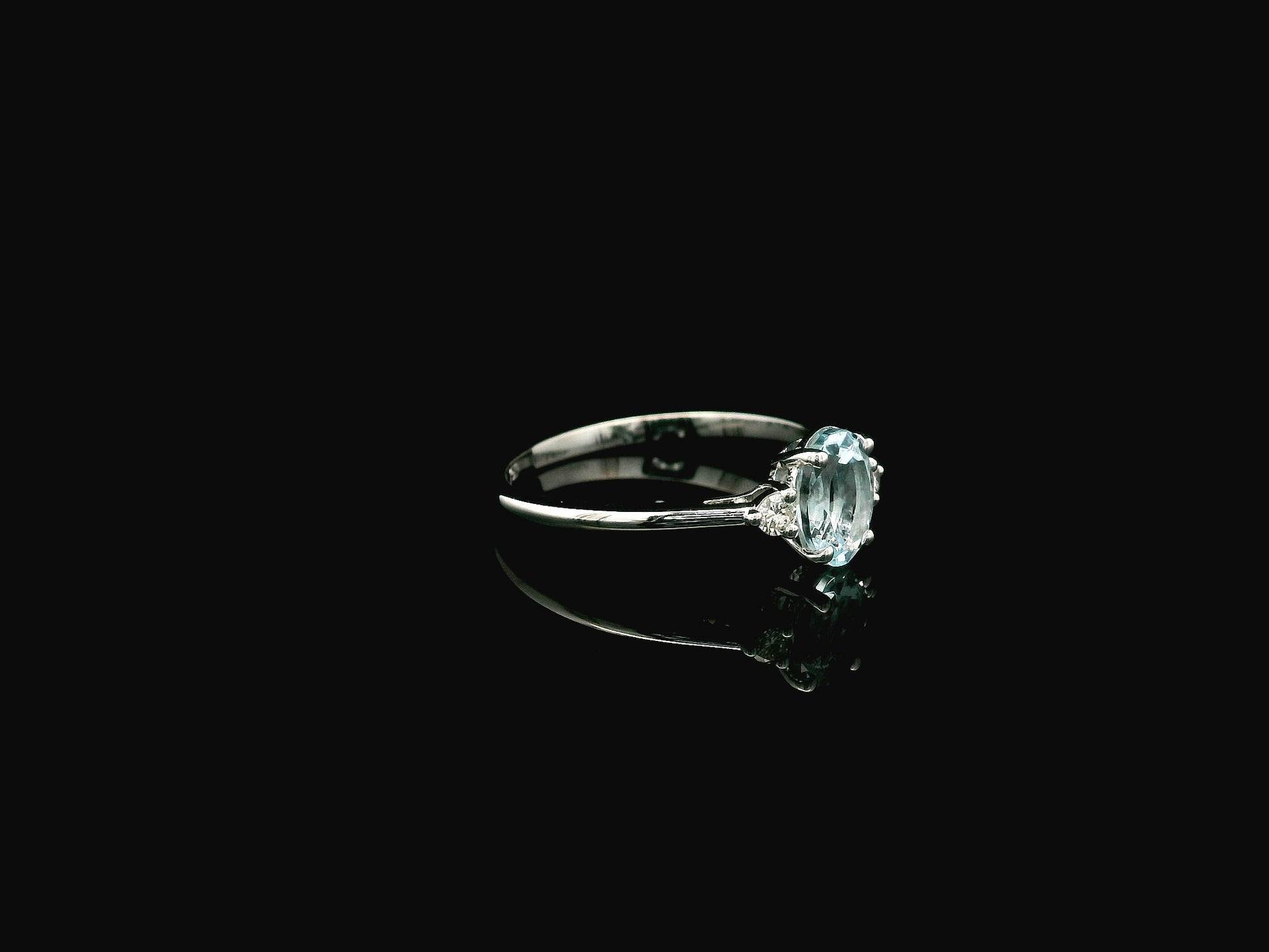 Oval aquamarine and diamond three stone ring in 18K white gold