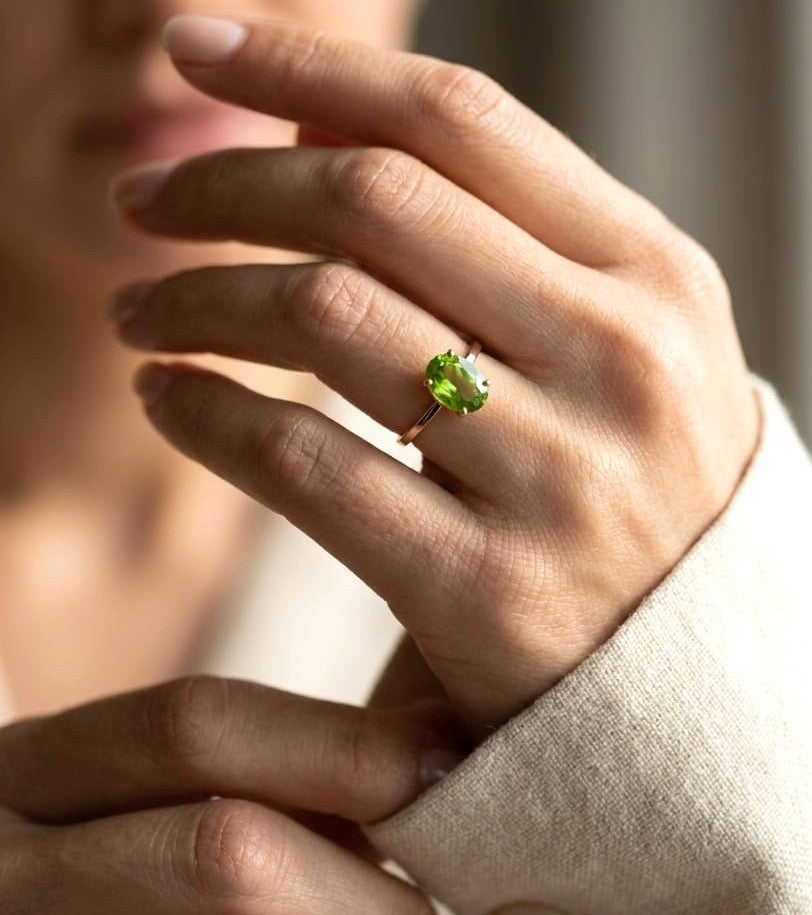 18K yellow gold oval peridot solitaire ring featuring a 2.17 carat natural peridot gemstone