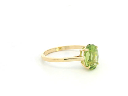 18K yellow gold oval peridot solitaire ring featuring a 2.17 carat natural peridot gemstone