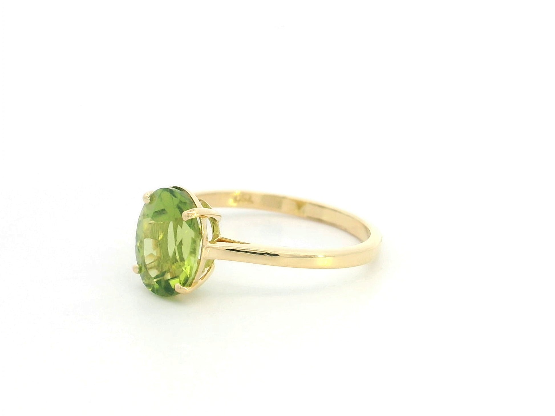 18K yellow gold oval peridot solitaire ring featuring a 2.17 carat natural peridot gemstone