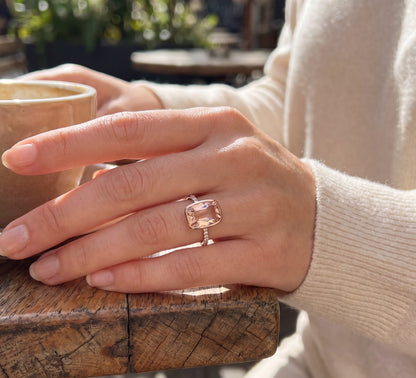 Emerald cut Morganite bezel set ring in 18K rose gold with diamond pavé band