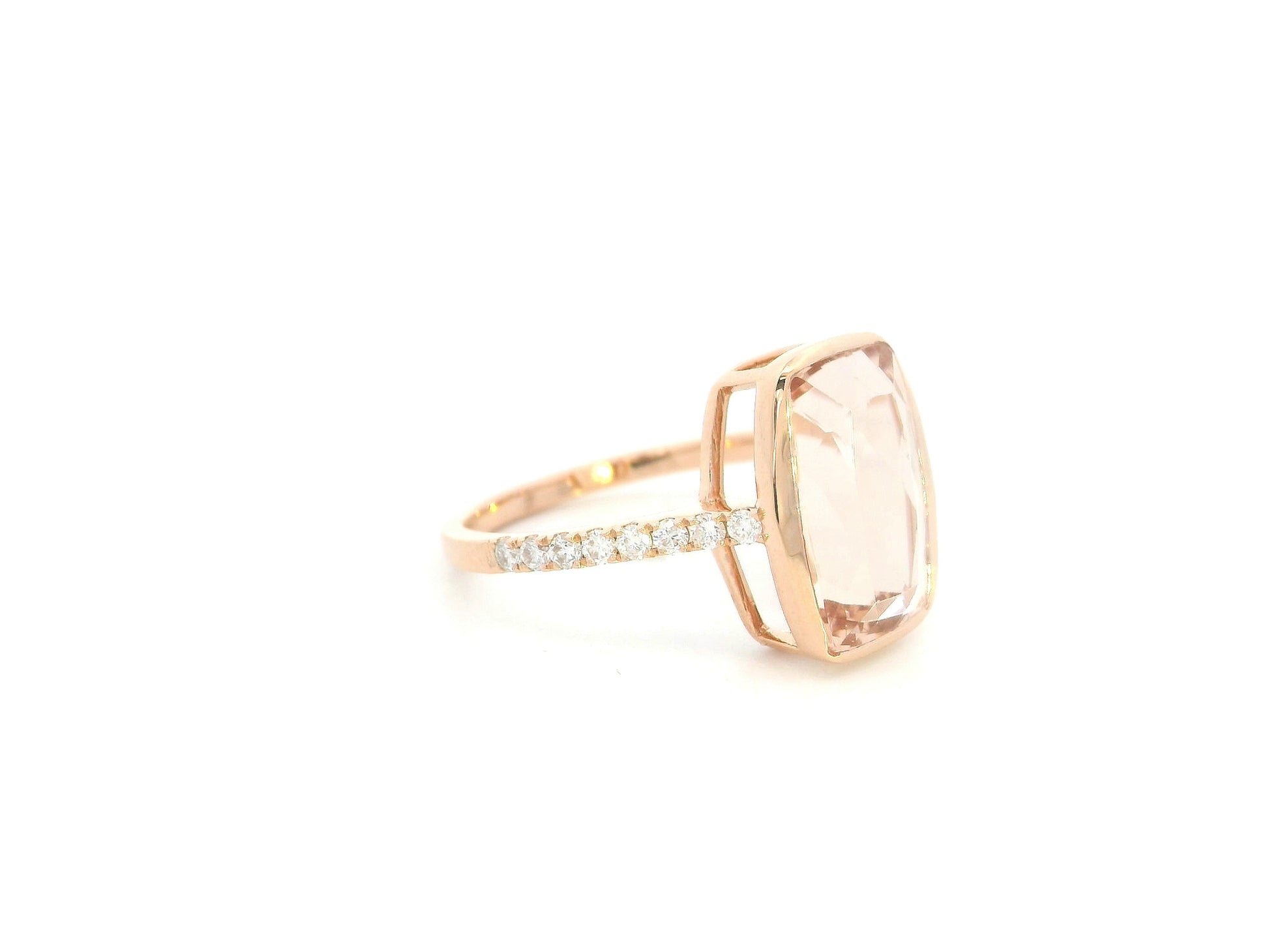 Emerald cut Morganite bezel set ring in 18K rose gold with diamond pavé band