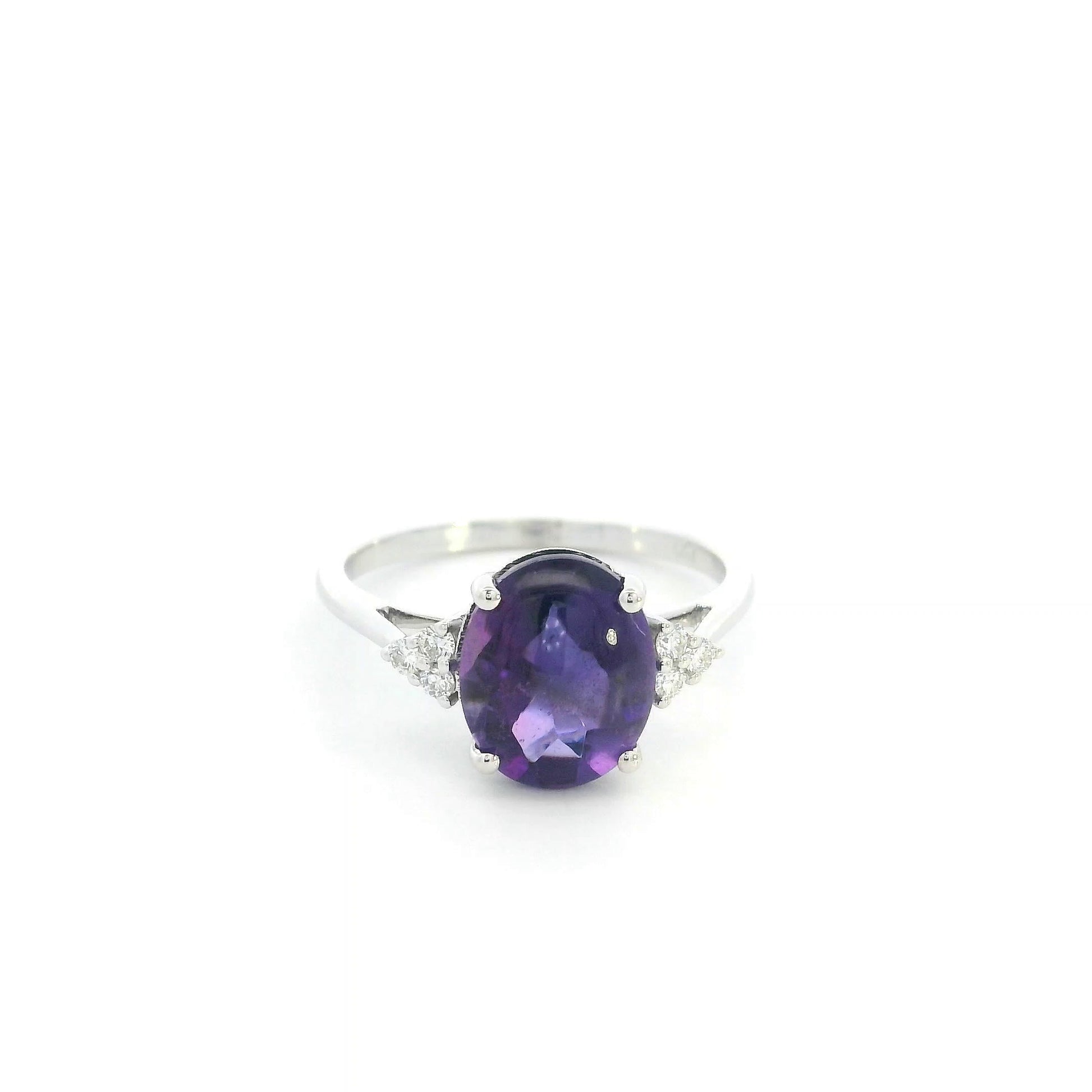 Natural oval cabochon amethyst ring in 18K white gold featuring a 2.92 carat purple amethyst and 0.08 carat natural diamond accents.