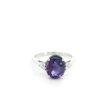 Natural oval cabochon amethyst ring in 18K white gold featuring a 2.92 carat purple amethyst and 0.08 carat natural diamond accents.