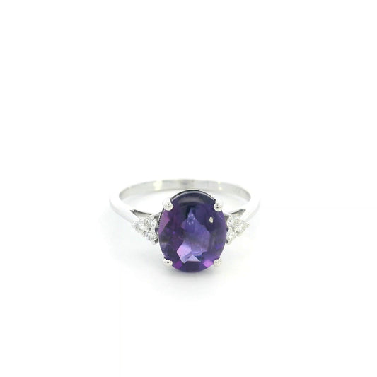 Natural oval cabochon amethyst ring in 18K white gold featuring a 2.92 carat purple amethyst and 0.08 carat natural diamond accents.