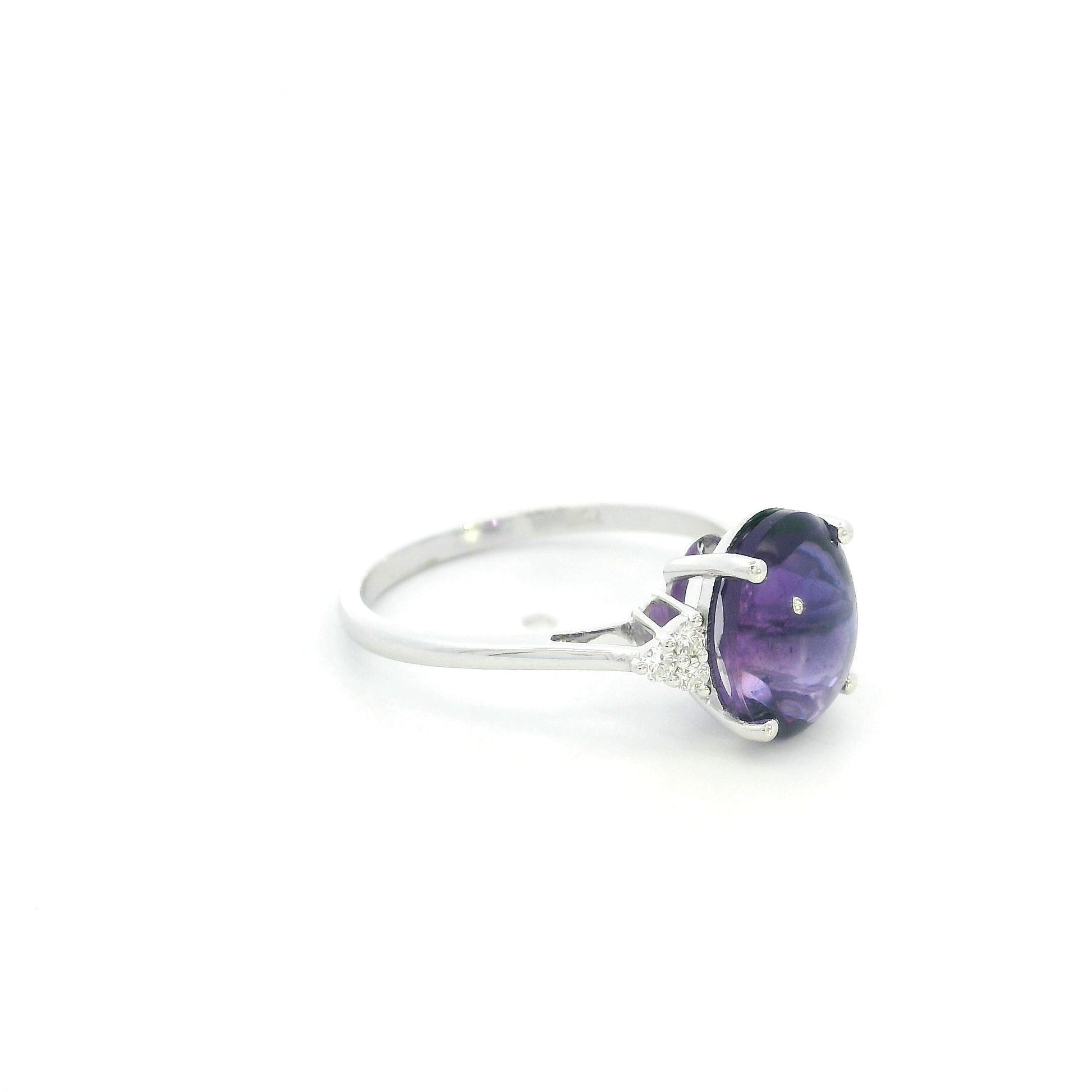Natural oval cabochon amethyst ring in 18K white gold featuring a 2.92 carat purple amethyst and 0.08 carat natural diamond accents.