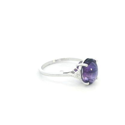 Natural oval cabochon amethyst ring in 18K white gold featuring a 2.92 carat purple amethyst and 0.08 carat natural diamond accents.