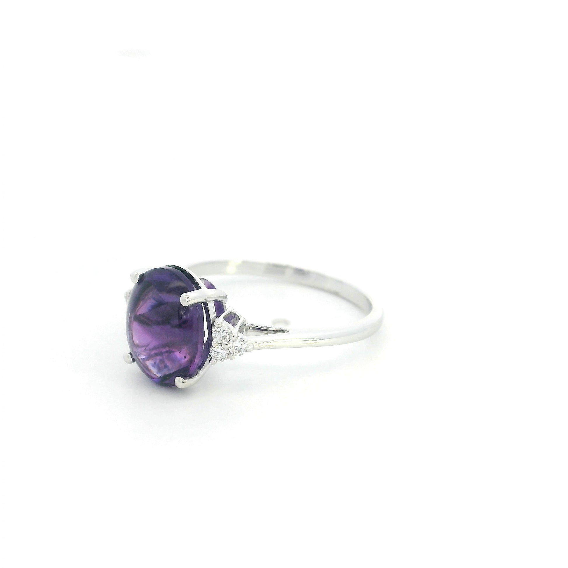 Natural oval cabochon amethyst ring in 18K white gold featuring a 2.92 carat purple amethyst and 0.08 carat natural diamond accents.