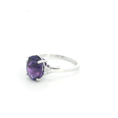 Natural oval cabochon amethyst ring in 18K white gold featuring a 2.92 carat purple amethyst and 0.08 carat natural diamond accents.