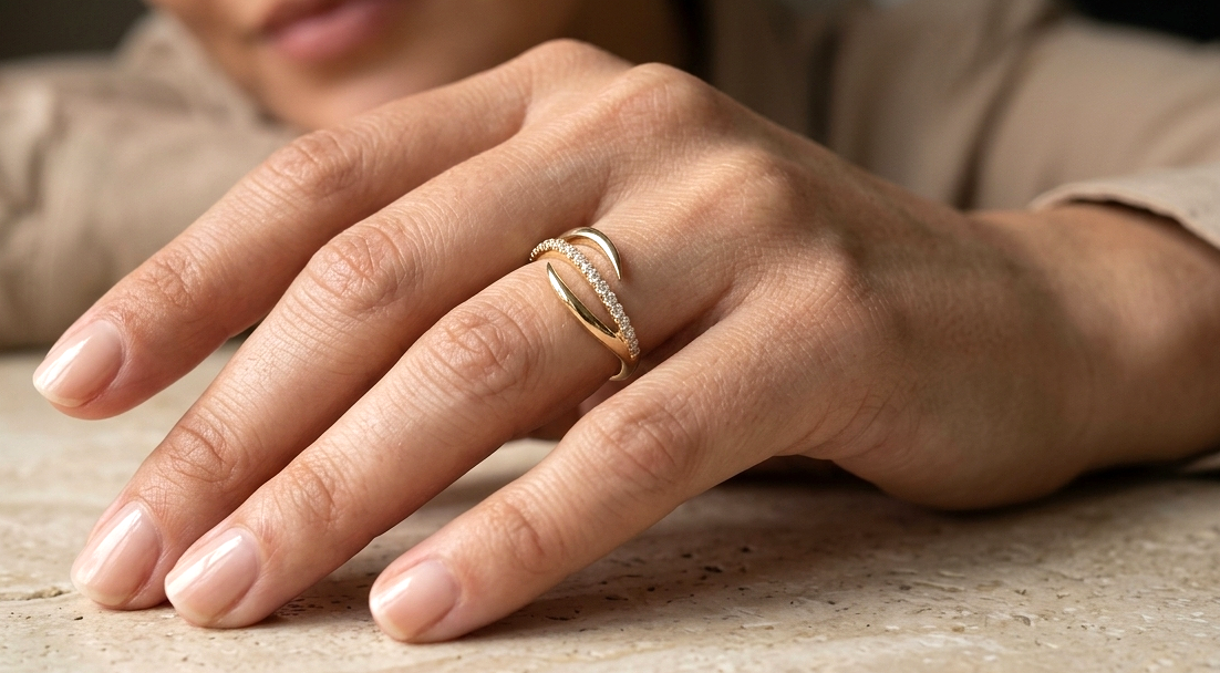 18K yellow gold diamond crossover ring featuring a flowing twist design set with 0.21 carat natural diamonds.